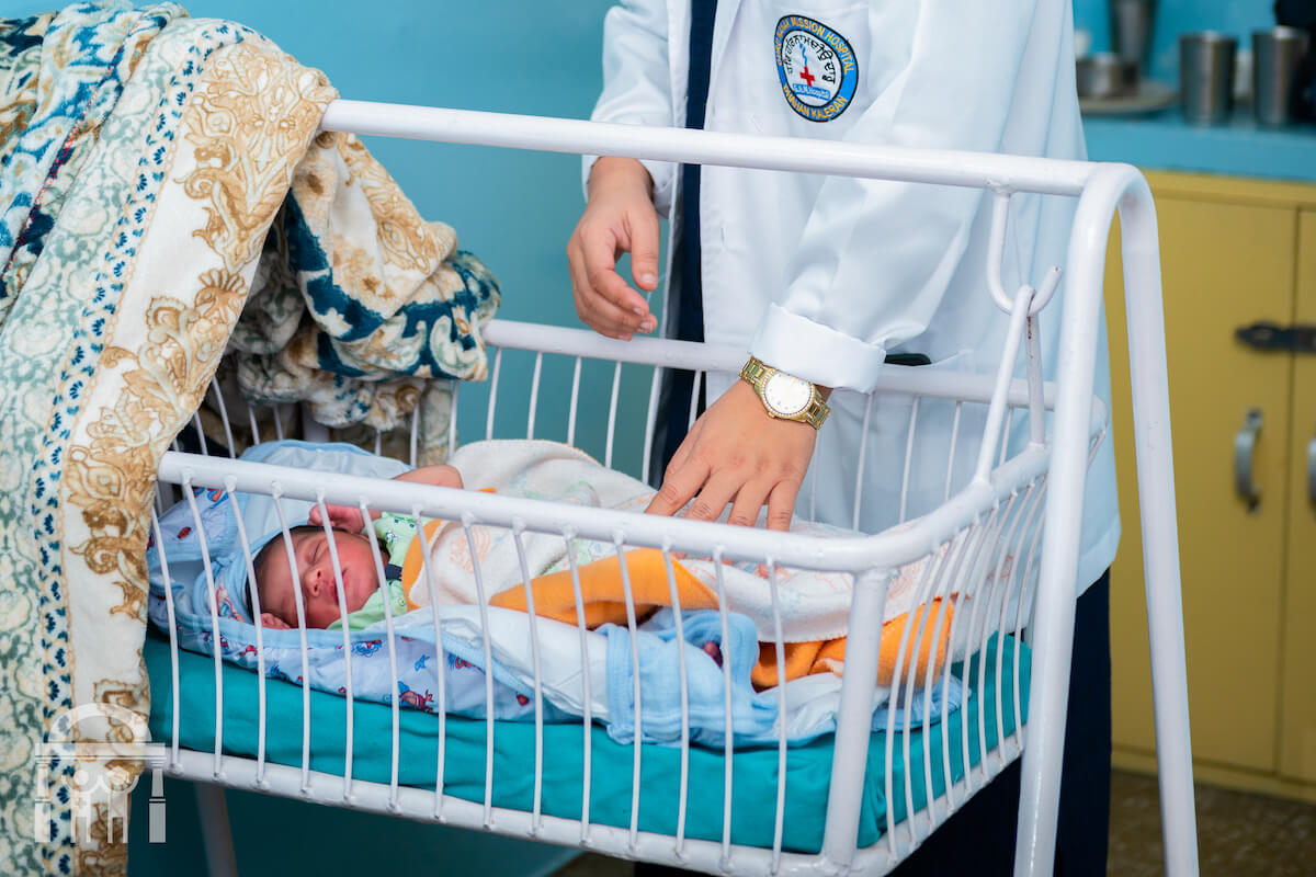 OBGYN doctor checking on baby in bassinet at Guru Nanak Mission Hospital Dhahan Kaleran near Banga in Punjab