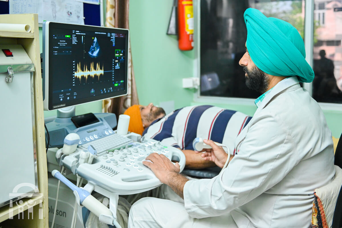 Doctor performing ultrasound procedure on patient with monitor at Guru Nanak Mission Hospital Dhahan Kaleran near Banga and Phagwara